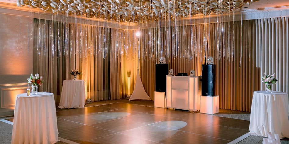 Photo of an elegantly decorated ballroom space with a dance floor surrounded by balloons