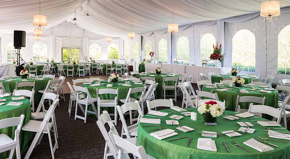 ABS Tables with green linens in an outdoor event setting