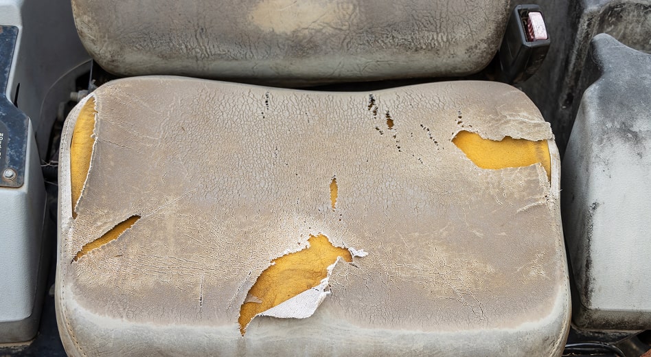 A tattered truck seat made of open cell (TDI) foam