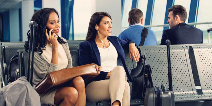 Business Women on Phone Waiting for Plane