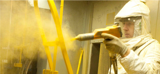 Man Powder Coating a Chair Frame