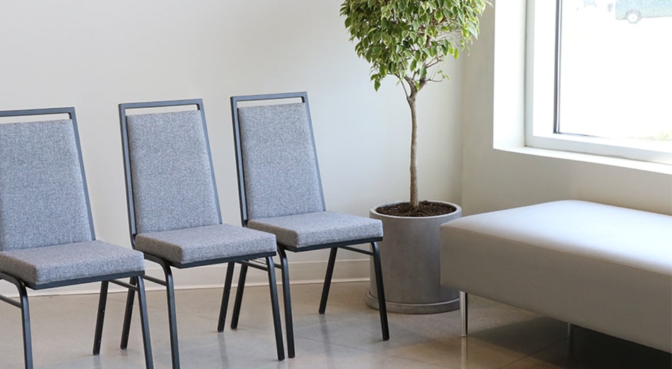 MityLite banquet chairs in a modern, minimal setting with a plant in the corner