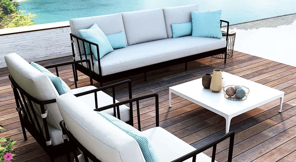 black metal outdoor furniture with white cushion on a modern wooden deck