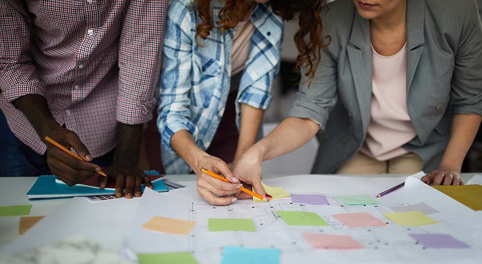 Group crowded around a desk making notes about the event space