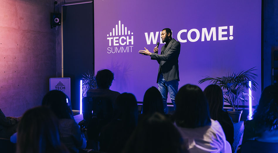 Speaker on stage at a small tech summit