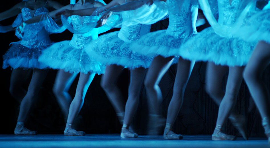 Ballerinas dancing across a stage