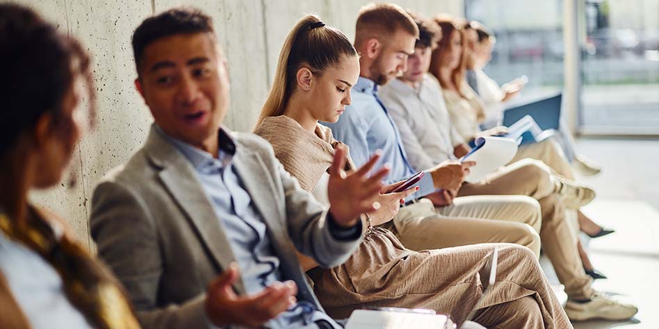 People seated side-by-side in a waiting area