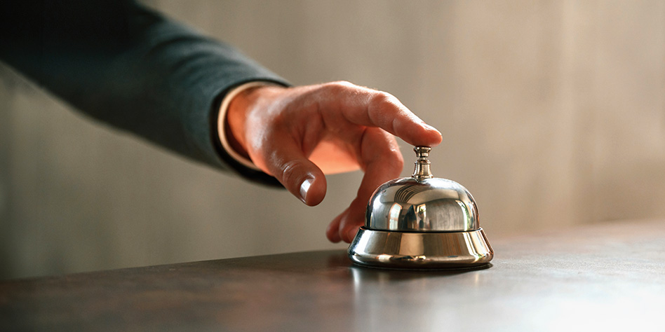 Close up of a hand ringing a reception bell