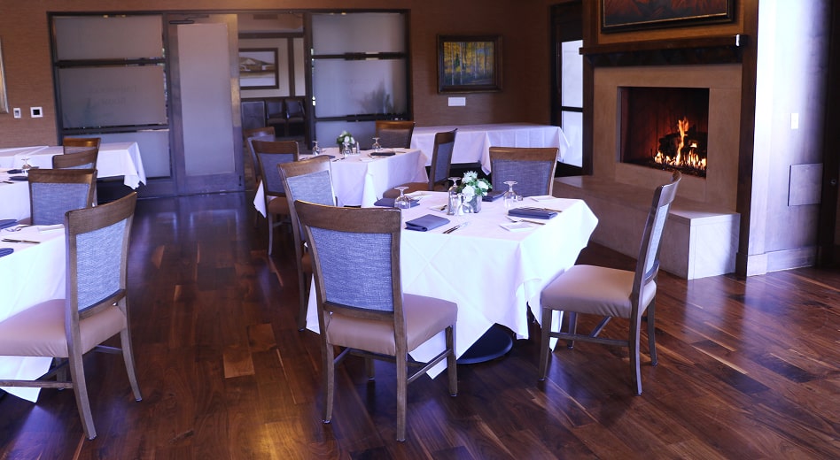 Solid wood side chairs at a fireside dining table.