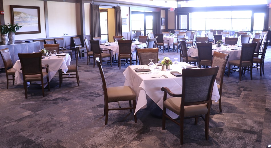 A formal table set with solid wood upholstered armchairs and side chairs.