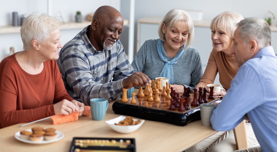 A group of senior citizens playing board games.