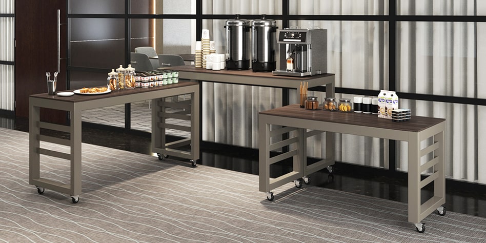 Three Imara Nesting Tables with coffee and pastries in a hotel lobby.