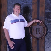 Property manager of Riverside Country Club standing in front of the door.