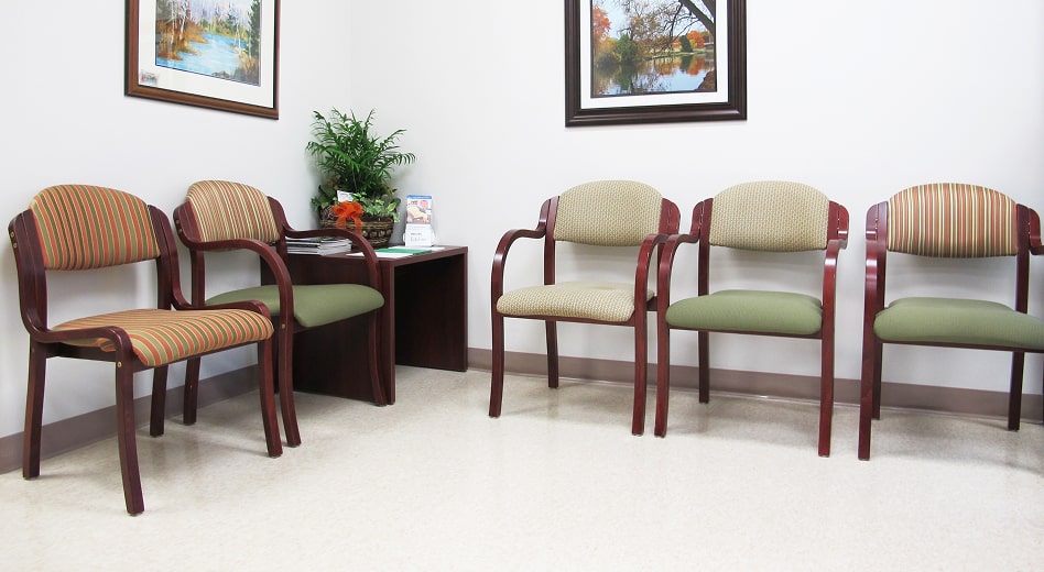 Wooden armchairs and side chairs in a waiting room at a doctor's office