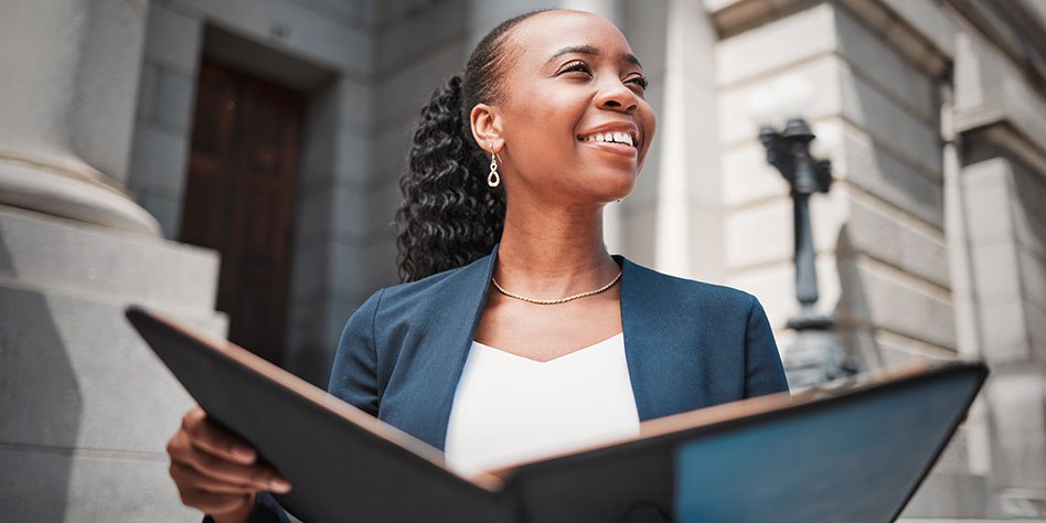 Employee standing in front of a government building