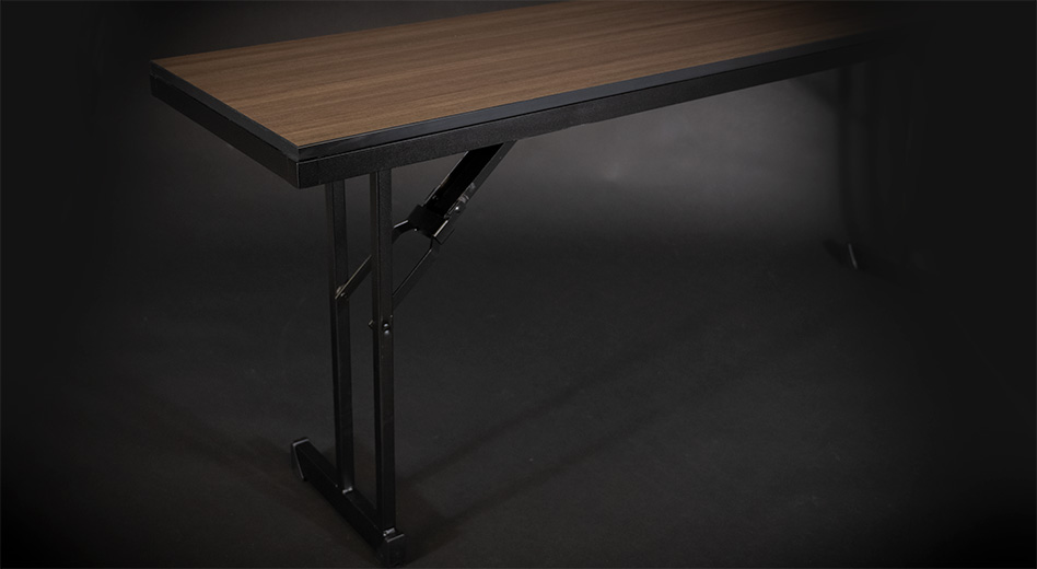 Um close-up da mesa Madera sem toalha de mesa sobre um fundo preto sombrio.