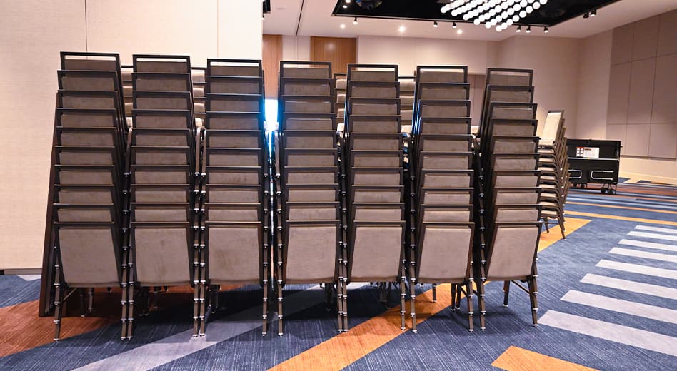 Stacks of chairs in a large convention center hallway