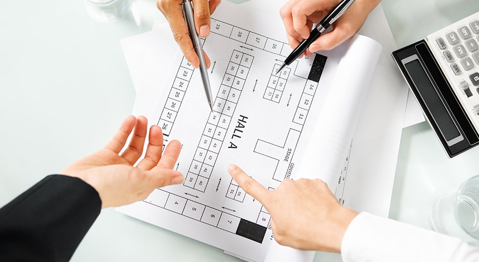 Close up of hands pointing at a facility map