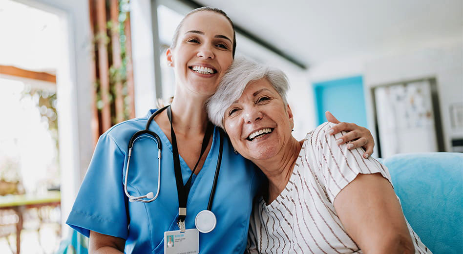 Close up of a senior woman and caregiver sharing a side hug