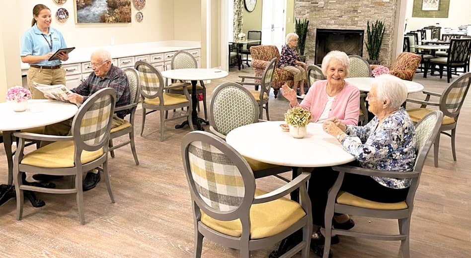 Seniors sitting an mingling in a multi-purpose space 