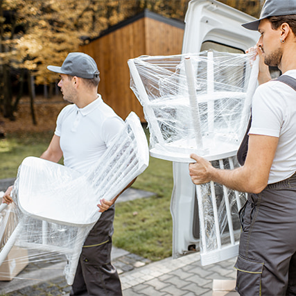 Set up crew moving chairs for an outdoor event