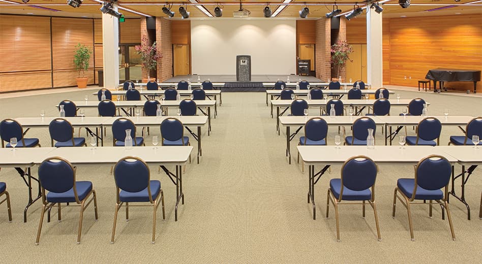 Banquet chairs and tables arranged for a conference workshop setting
