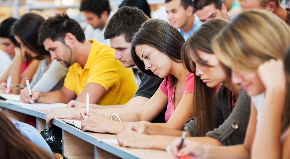 Large group of university students in a lecture-style classroom