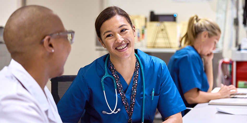 A young nurse chatting with a doctor