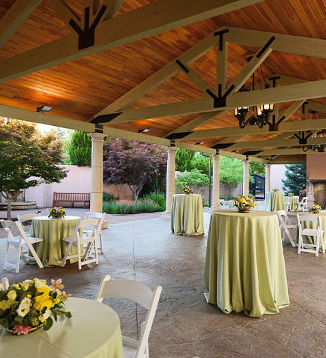Posh wedding decor in a tasteful patio setting under a pergola