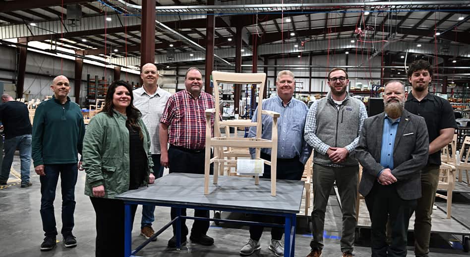 MITY employees standing on the shop floor and smiling