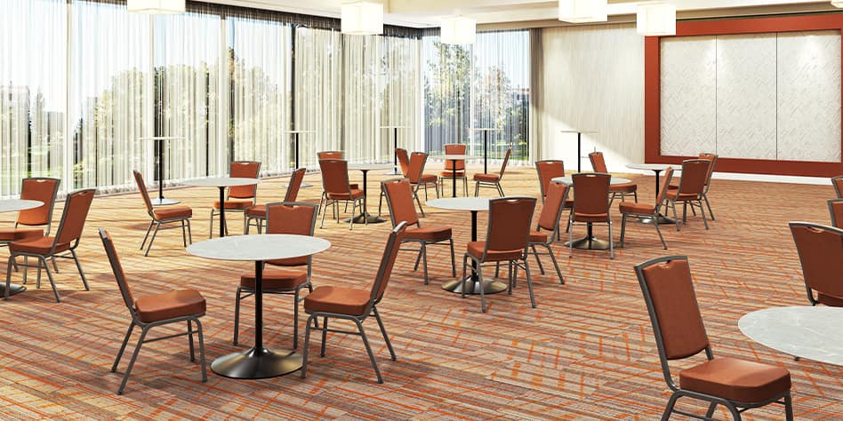 Warmly lit and minimally furnished hotel meeting space